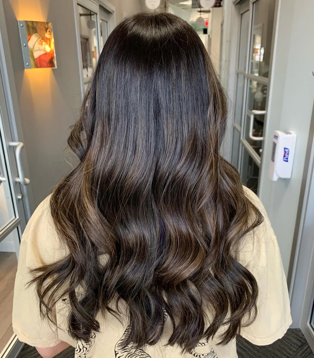 Glossy dark brunette waves with soft dimension